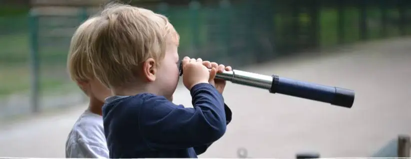a child looking through a telescope